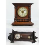 A 19th century Vienna eight day wall clock with shaped mask decorated pediment,