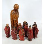 A set of eight modern Chinese earthenware figures of dignitaries in red robes,
