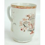 A 19th century Chinese Export porcelain mug painted in enamels and iron red with floral sprays,