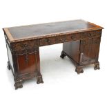 A good early 20th century mahogany Chippendale style twin pedestal desk,