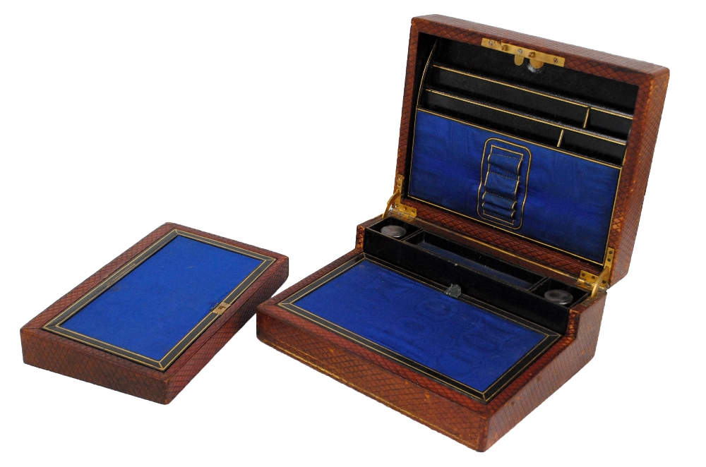A Victorian leather travelling writing slope with hinged lid enclosing a fitted interior stamped