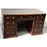 A mid-20th century oak kneehole desk with four drawers to either side.