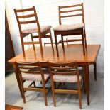 A retro teak extending rectangular dining table on tapering supports,