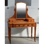 A Victorian pine two-drawer dressing table raised on turned supports, with swing mirror upstand,