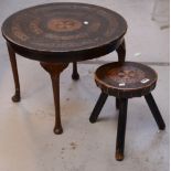 An Oriental-style circular table with tooled leather top and a matching stool (2).