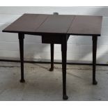 An early 19th century mahogany drop-leaf dining table raised on tapering supports,