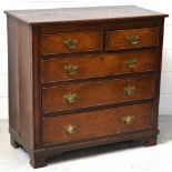A 19th century oak two-over-three chest of drawers with brass shield-shaped handles and escutcheons,