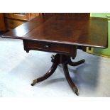 A late 19th-early 20th century mahogany sofa table on pedestal and quatrefoil supports,