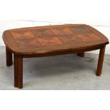 A 1970s teak coffee table with squares of marquetry-inlaid panels, length 112cm.