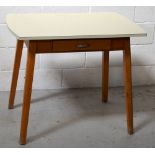 A c1950s Formica kitchen table on splayed supports, 92 x 60cm.