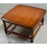 A modern Ercol elm square coffee table on turned legs with stretchers, width 75cm.