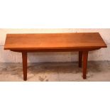 A retro small coffee table on tapering turned supports, length 92cm.