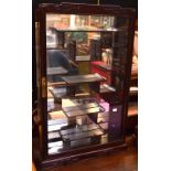 An Oriental-style display cabinet with mirror back to interior,