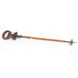 A late 19th century/early 20th century shooting stick with walnut hinged seat spring action and