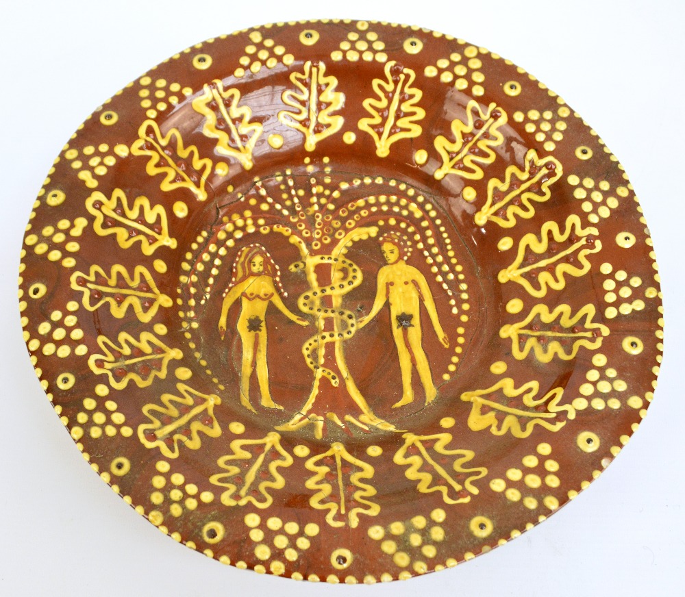 A 19th century Staffordshire slipware 'Adam and Eve' charger,