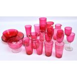 A group of cranberry glass to include a set of six wine glasses, two beakers, a jug and two plates.