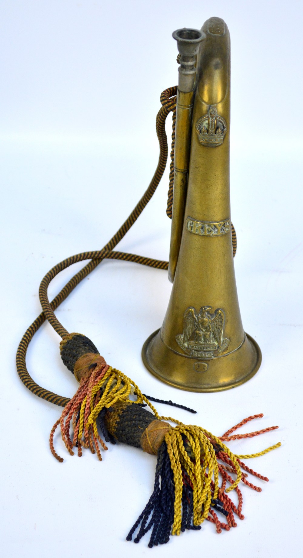 A regimental bugle with cord and tassels for Royal Scots Greys, impressed to body 'Ypres 1914 15'.