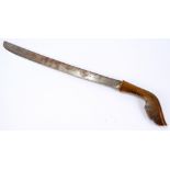 A 19th century rhinoceros horn handled hunting knife with shaped grip and slightly curved blade,