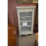 A 19th century French cream painted vitrine with moulded rectangular cornice above single glazed