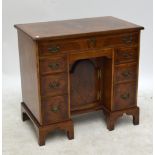 A reproduction burr walnut featherbanded and crossbanded kneehole desk in the Georgian manner with