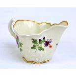 A circa 1800 Worcester cream jug with wrythen moulded body, painted with floral sprays, length 12cm.