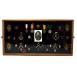 A single soldier collection comprising WWI Trio, Volunteer Long Service Medal, regimental badges,