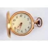 A continental 14ct gold crown wind fob watch with white enamel dial set with Arabic numerals and