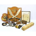 A quantity of mixed militaria to include a mounted pair of Gurkha kukri knives and related badges,
