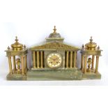 A late 19th century/early 20th century French three piece mantel clock garniture comprising an onyx