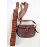 A leather cartridge bag on canvas strap and a leather cartridge belt (2).