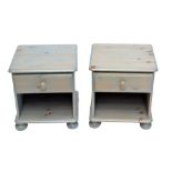 A pair of modern pine bedside cabinets.