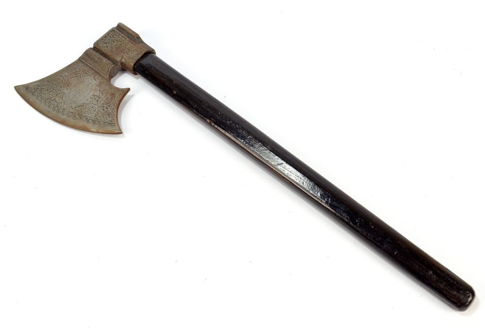 An ebonised shafted axe with engraved blade, length 49cm.