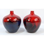 A pair of Royal Doulton flambé veined glazed squat baluster vases with raised necks,