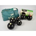 A pair of Thomas Taylor 2-8 bowling balls contained within a ball bag and a further pair of Lignoid