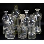 Six early 20th century clear glass decanters with waisted bodies and a further example (7).