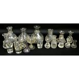 A large collection of Victorian whisky dispensers and measures with the majority of lobed form,