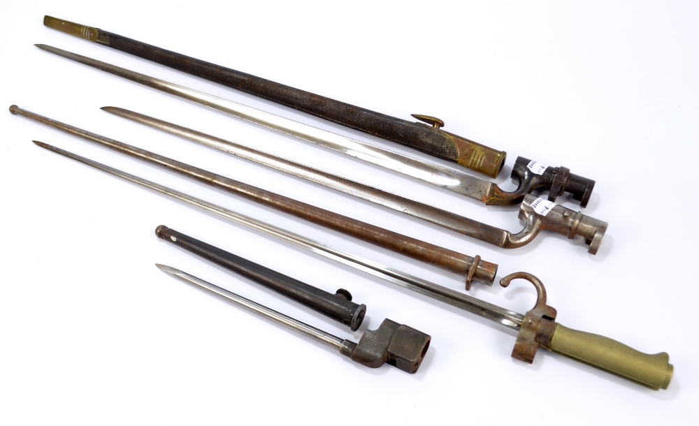 Four socket bayonets, one with leather scabbard, two with metal scabbard, one lacking scabbard,