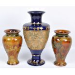 A pair of Royal Doulton 'Autumn Leaves' pattern decorated stoneware vases of inverted baluster form,