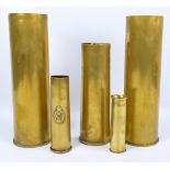 Five brass shell cases, largest 37cm, smallest 15.