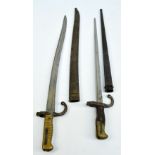 Two 19th century sword bayonets, the larger stamped J 13988 to quillon and scabbard,