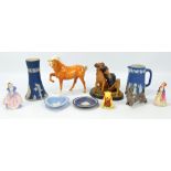 A small group of ceramic figures comprising a Beswick Palomino horse,
