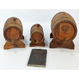 Three vintage brass bound wine casks of graduating size on stands (3).