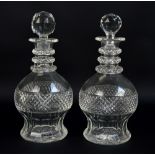 A pair of early 19th century cut glass triple ring net neck decanters,