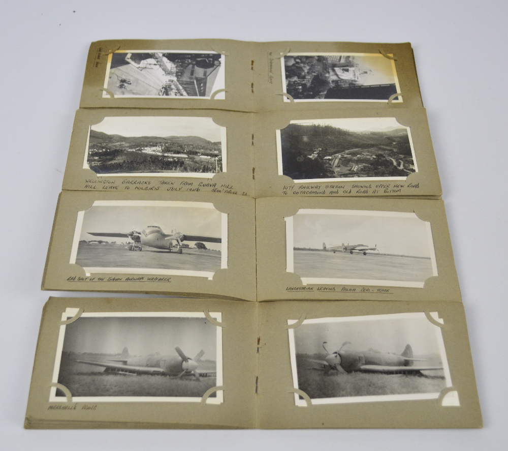Four small photograph albums containing black and white military related photographs,