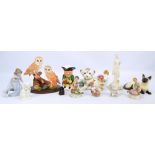 A group of various ceramic figures to include a girl with puppy,