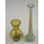 A Roman glass long neck vase, height 22cm, an amber tinted Roman vase with mineral iridescence,