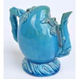 A 19th century turquoise glazed Cadogan type teapot with typical moulded spout,