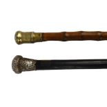 A Victorian hallmarked silver mounted ebonised walking cane and a further brass mounted bamboo