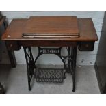 A Singer cabinet treadle sewing machine.