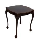 An early 20th century walnut occasional table with shaped top raised on four knee carved cabriole